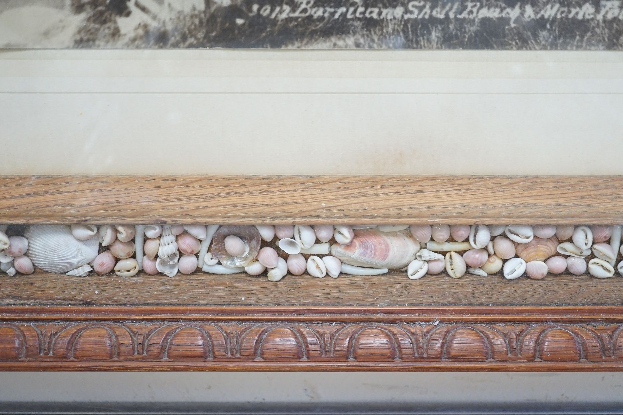 An oak and coloured shell picture frame, 49 x 53cm.